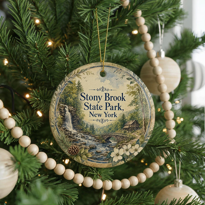 A round ornament hanging on a Christmas tree, featuring a scenic image of Stony Brook State Park in New York.
