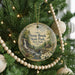 A round ornament hanging on a Christmas tree, featuring a scenic image of Stony Brook State Park in New York.