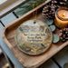A wooden tray with a decorative ornament featuring a scenic landscape of Sun Lakes and Dry Falls State Park in Washington.