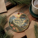 A decorative ornament featuring a scenic landscape of Sunset Bay State Park, Oregon, with a sunset over the water and pine trees in the foreground.