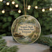 A circular ornament with a scenic image of Sycamore Shoals State Historic Park, Tennessee, featuring a log cabin and a river.