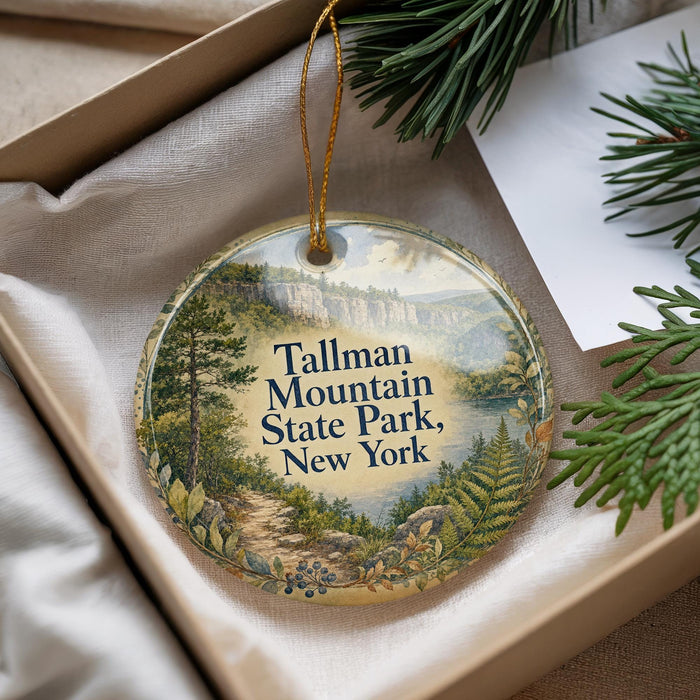 A decorative ornament with a scenic landscape of Tallman Mountain State Park, New York, hanging from a string.