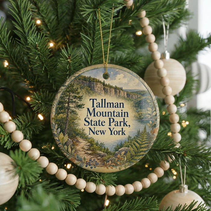 A round ornament on a Christmas tree, featuring a scenic image of Tallman Mountain State Park in New York.