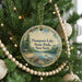 A round ornament hanging on a Christmas tree, featuring a scenic image of Thompson's Lake State Park, New York.