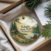 A round ornament with a scenic landscape of Tolmie State Park in Washington, featuring a cabin, pine trees, and a lake.