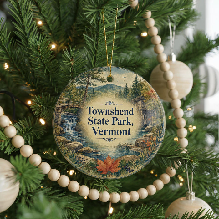 A round ornament on a Christmas tree, featuring a scenic landscape with a waterfall and mountains, with the text "Townshend State Park, Vermont" displayed prominently.