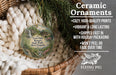Ceramic ornaments, featuring a round ornament with a scenic image of Twin Falls Resort State Park, West Virginia, hanging from a wicker basket.