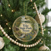 A round ornament hanging on a Christmas tree, featuring a scenic image of Tyler State Park, Texas.