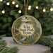 A circular ornament with a scenic image of Tyler State Park, Texas, featuring a cabin, a waterfall, and a forest.
