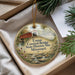 A decorative ornament with a painting of a covered bridge and a river, surrounded by greenery, placed in a box.
