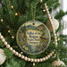 A round ornament hanging on a Christmas tree, featuring a scenic image of the valley of the Rogue State Park, Oregon.