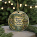 A round ornament with a scenic landscape of mountains, trees, and a river, featuring a bird perched on a rock.