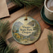 A decorative ornament with the text "Viento State Park, Oregon" is displayed on a wooden surface, surrounded by pine branches and a cup of coffee.