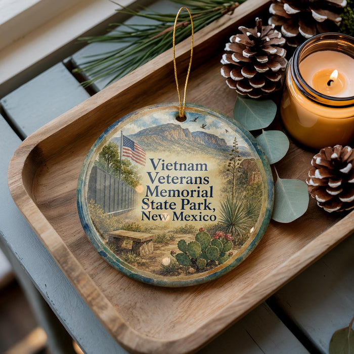 A decorative ornament featuring a scenic image of Vietnam Veterans Memorial State Park in New Mexico, with a candle and pine cones on a wooden tray.