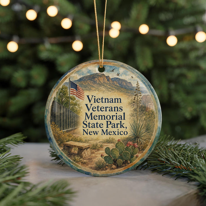 A round ornament with a picture of a memorial park, specifically Vietnam Veterans Memorial State Park in New Mexico, surrounded by greenery and a cactus.
