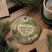 A decorative ornament with the text "Village Creek State Park, Texas" is displayed on a wooden surface, surrounded by pine branches and a cup of coffee.