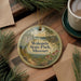 A circular ornament with a scenic landscape of Wokonda State Park, Missouri, featuring a winding path, pine trees, and a cabin in the background.