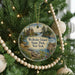 A circular ornament hanging on a Christmas tree, featuring a scenic image of Wellesley Island State Park in New York.