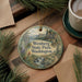 A decorative ornament with a scenic landscape of Wenberg State Park, Washington, featuring pine trees, a waterfall, and mountains.