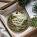A round ornament with a scenic image of West Branch State Park, Ohio, hanging from a string.