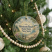 A round ornament hanging on a Christmas tree, featuring a scenic image of Westcott Beach State Park, New York.