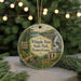 A round ornament with a scenic image of Whipple Dam State Park, Pennsylvania, hanging on a string.