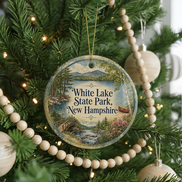 A Christmas tree decorated with ornaments, including a circular ornament with a scenic image of White Lake State Park, New Hampshire.