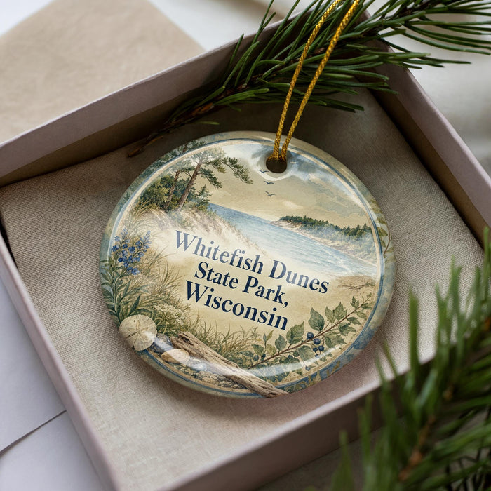 A decorative ornament in a box, featuring a scenic landscape with a lake, pine trees, and a bird in flight.