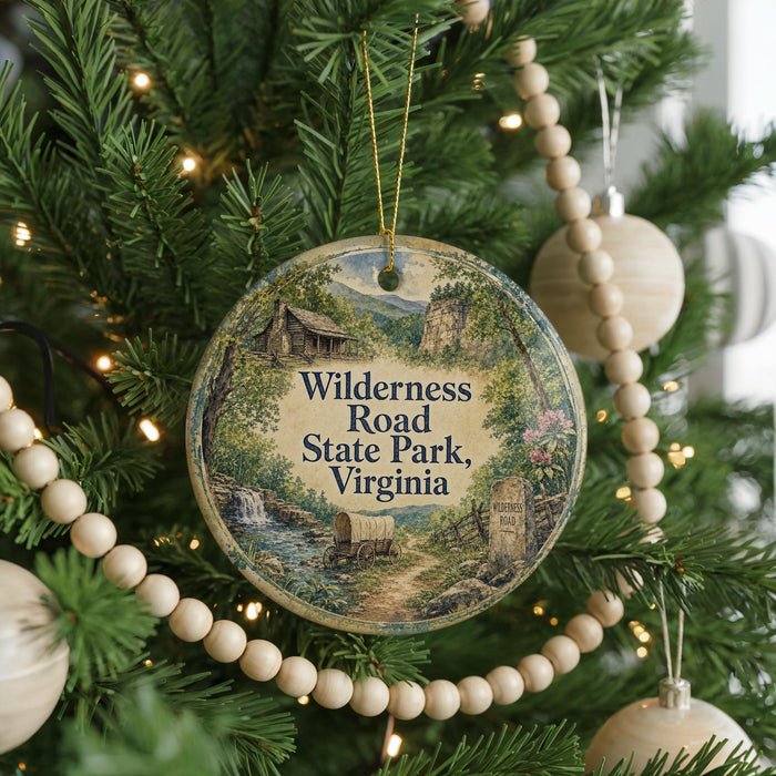 A Christmas tree decorated with ornaments, including a round ornament with a scenic image of Wildness Road State Park, Virginia.