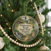 A Christmas tree decorated with ornaments, including a round ornament with a scenic image of Wildness Road State Park, Virginia.