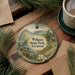 A round ornament with a scenic landscape of Wilgus State Park, Vermont, featuring a river, mountains, and pine trees.