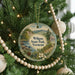 A round ornament hanging on a Christmas tree, featuring a scenic landscape of Wilgus State Park, Vermont.