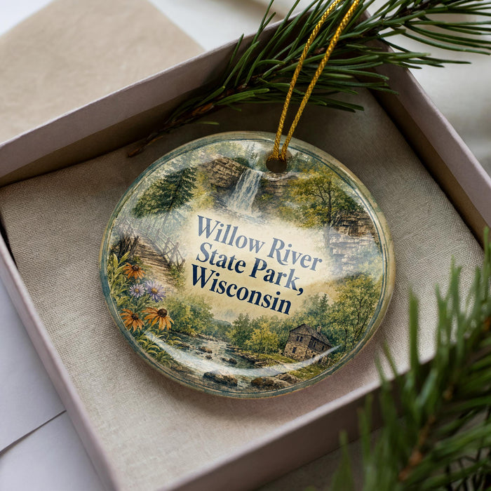 A decorative ornament in a box, featuring a scenic image of the Willow River State Park in Wisconsin.