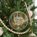 A round ornament hanging on a Christmas tree, featuring a scenic image of Willow River State Park in Wisconsin.