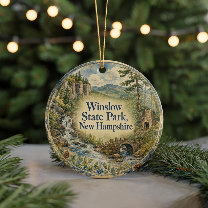 A round ornament with a scenic image of Winslow State Park, New Hampshire, featuring a waterfall and a bridge.