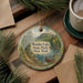 A decorative ornament featuring a scenic landscape of Wonder Lake State Park, New York, with a canoe on the lake and pine trees in the background.