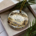 A decorative ornament in a box, featuring an illustration of a historic prison and the text "Wyoming Territorial Prison State Historic Site, Wyoming".