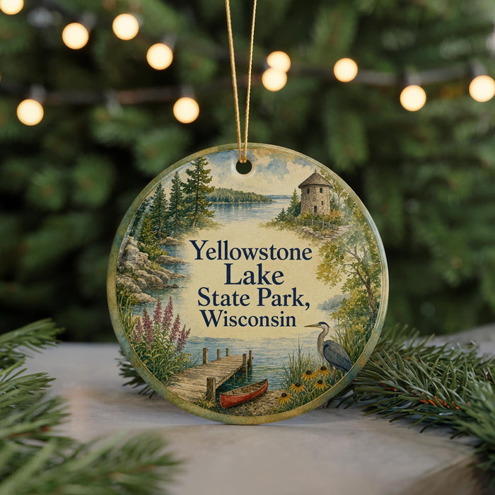 A decorative ornament featuring a scenic landscape of Yellowstone Lake, Wisconsin, with a bird and a dock in the foreground.