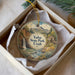 A decorative ornament in a box, featuring a scenic landscape with a waterfall and mountains, along with the text "Yuba State Park, Utah".