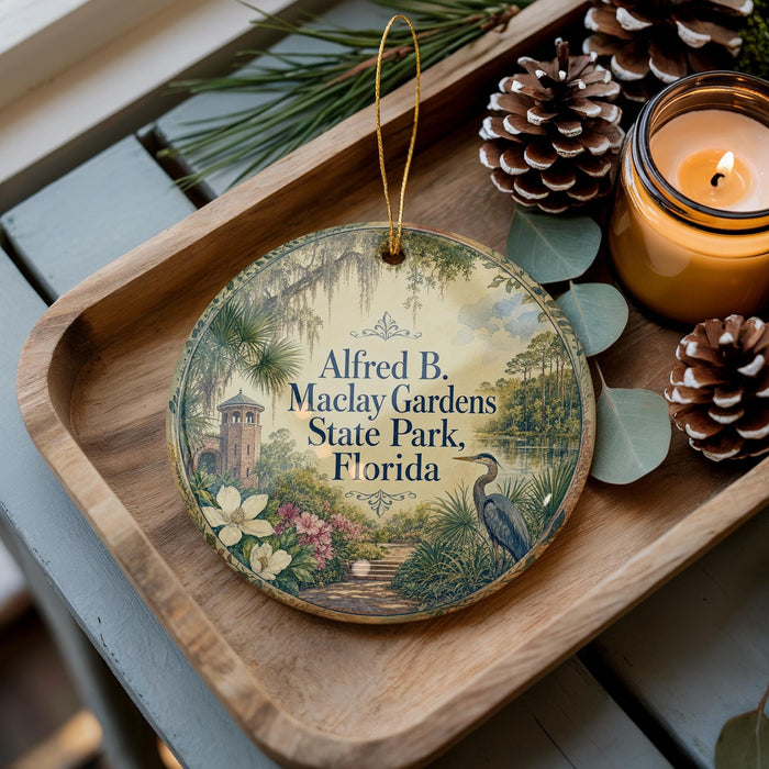 A wooden tray with a decorative ornament featuring a bird and a tropical garden scene, along with pine cones and a lit candle.