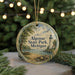 A round ornament with a lighthouse and a picnic table, surrounded by greenery and a string of lights.