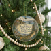A round ornament hanging on a Christmas tree, featuring an illustration of Angel Island, California.