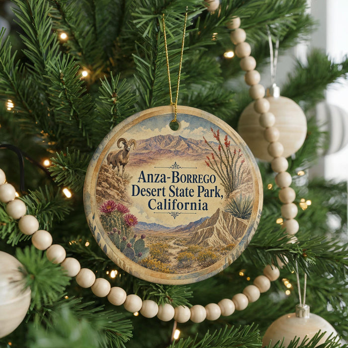 A round ornament hanging on a Christmas tree, featuring a desert landscape with mountains and cacti.