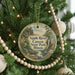 A round ornament hanging on a Christmas tree, featuring a scenic image of the Apple River Canyon State Park in Illinois.