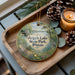 A decorative ornament featuring a scenic view of Argyle Lake State Park, Illinois, with pine cones and a lit candle on a wooden tray.