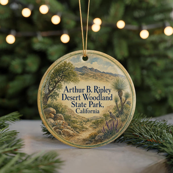A circular ornament with a desert landscape and a bird on a branch, featuring text that says "Arthur B. Ripley Desert Woodland State Park, California".