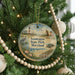 A round ornament hanging on a Christmas tree, featuring a lighthouse, a bird, a horse, and a turtle, with the text "Assateague State Park, Maryland" displayed on it.