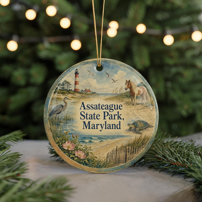 A round ornament with a lighthouse and a horse, surrounded by greenery and a beach scene, hangs in front of a Christmas tree with twinkling lights.