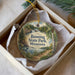A decorative ornament in a box, featuring a scenic landscape with a river, trees, and a bird, along with the text "Banning State Park, Minnesota".