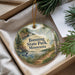 A decorative ornament with a scenic landscape of Banning State Park, Minnesota, featuring a lake, mountains, and pine trees.